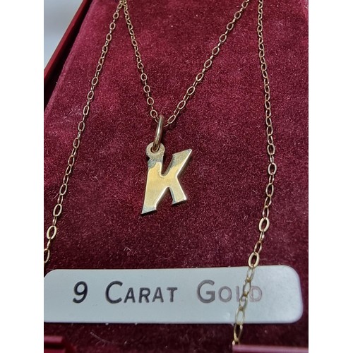 256 - A hallmarked 9ct gold neckless with the letter K pendant in good clean condition boxed, total weight... 