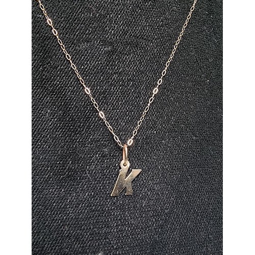 256 - A hallmarked 9ct gold neckless with the letter K pendant in good clean condition boxed, total weight... 