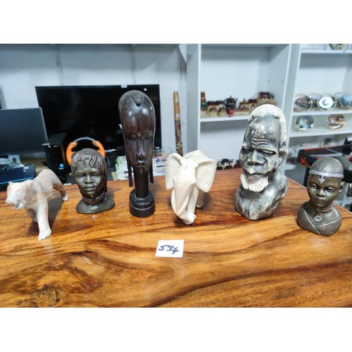 534 - A selection of five ceramic busts ethnic figurines and elephant etc all heavy solid items