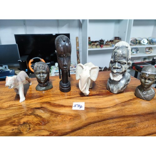 534 - A selection of five ceramic busts ethnic figurines and elephant etc all heavy solid items