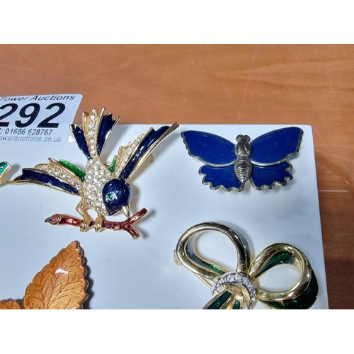 292 - Collection of 9x good quality enamel brooches featuring 3x flower brooches with ornate designs a map... 