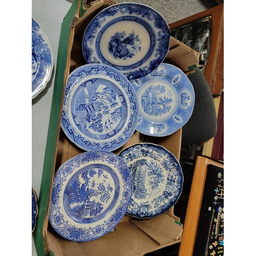 93 - 2x boxes containing a large quantity of blue and white design plates, bowls, chop plates inc Old Wil... 