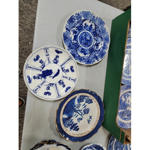 93 - 2x boxes containing a large quantity of blue and white design plates, bowls, chop plates inc Old Wil... 