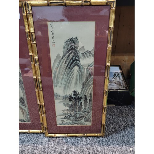 117 - Pair of famed and glazed bamboo gilt framed oriental signed pictures depicting a waterfall and lake ... 