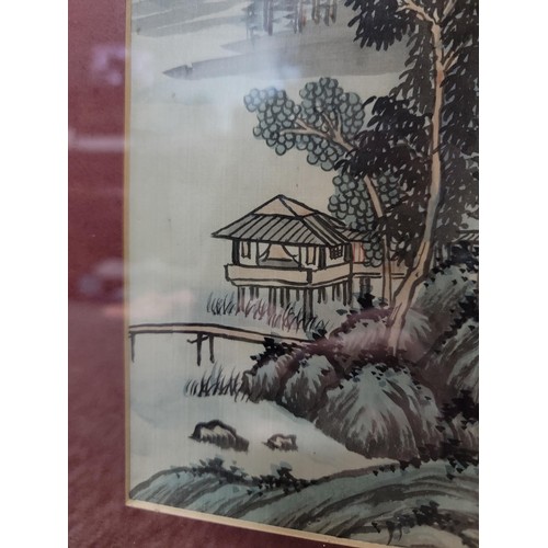 117 - Pair of famed and glazed bamboo gilt framed oriental signed pictures depicting a waterfall and lake ... 