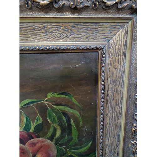 120 - Framed oil on board of a still life scene of peaches in a bowl, in an ornate gilt frame, signed to l... 