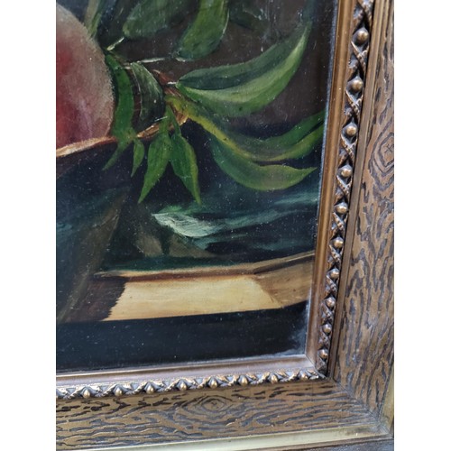 120 - Framed oil on board of a still life scene of peaches in a bowl, in an ornate gilt frame, signed to l... 