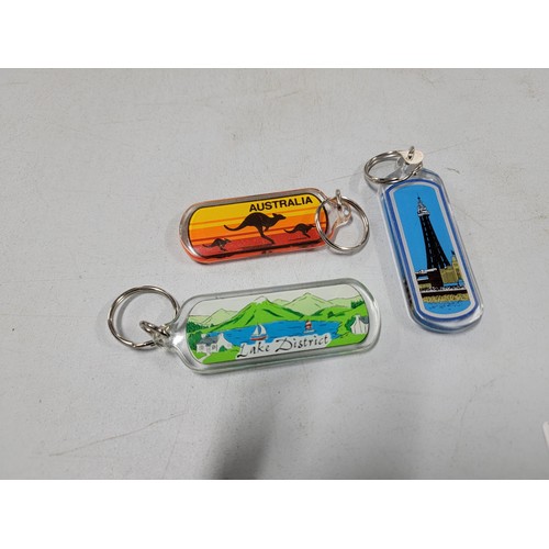 126 - Large quantity of collectable key rings inc surf boards, Florida, Scotland, Blackpool tower etc