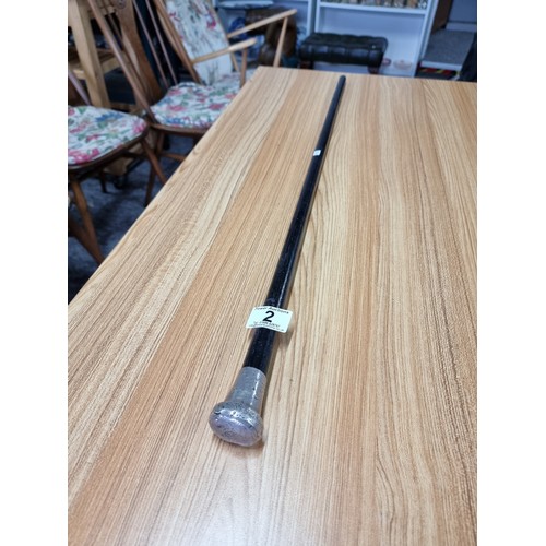 2 - An antique hallmarked silver top ebonised walking cane, the silver top has some damage. Length of 84... 