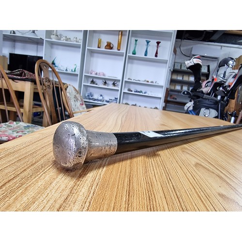 2 - An antique hallmarked silver top ebonised walking cane, the silver top has some damage. Length of 84... 