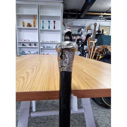 2 - An antique hallmarked silver top ebonised walking cane, the silver top has some damage. Length of 84... 