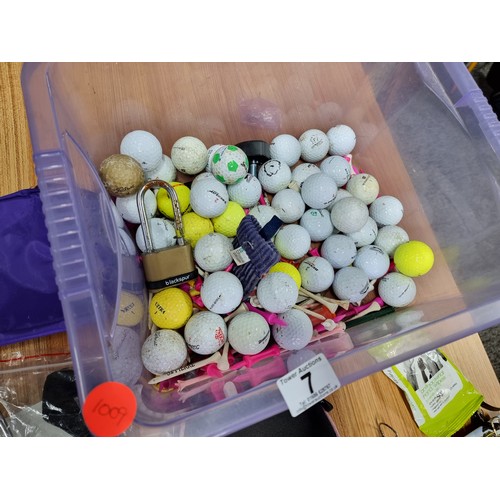 7 - A box full of golfing accessories to include a large quantity of golf balls of various makes, golf t... 