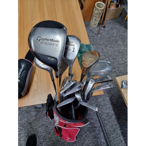 8 - A set of right handed golf clubs in a Nike bag to include 2 TaylorMade drivers, 2 vintage woods by A... 