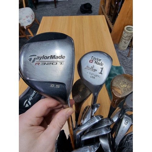 8 - A set of right handed golf clubs in a Nike bag to include 2 TaylorMade drivers, 2 vintage woods by A... 