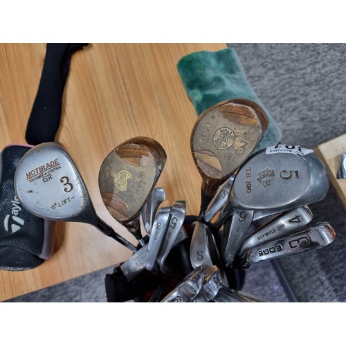 8 - A set of right handed golf clubs in a Nike bag to include 2 TaylorMade drivers, 2 vintage woods by A... 