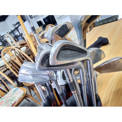 8 - A set of right handed golf clubs in a Nike bag to include 2 TaylorMade drivers, 2 vintage woods by A... 