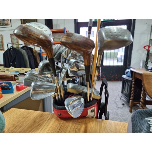 8 - A set of right handed golf clubs in a Nike bag to include 2 TaylorMade drivers, 2 vintage woods by A... 