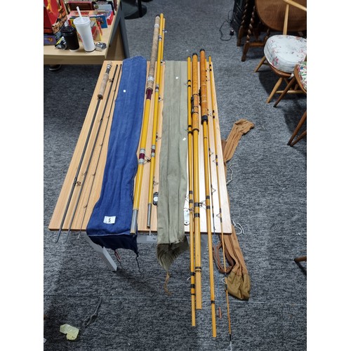 9 - A collection of 3x good fishing rods to include a K five piece combo hollowed glass rods set, a 3 pi... 