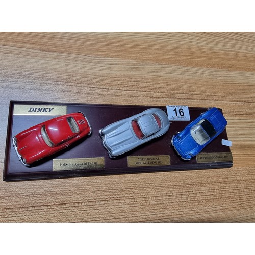 16 - A Dinky 3x model diecast sports car set all attached to a presentation plinth to include a Ferrari D... 