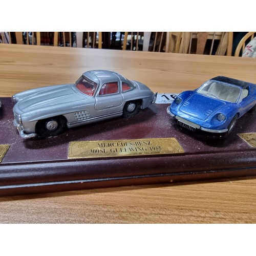 16 - A Dinky 3x model diecast sports car set all attached to a presentation plinth to include a Ferrari D... 