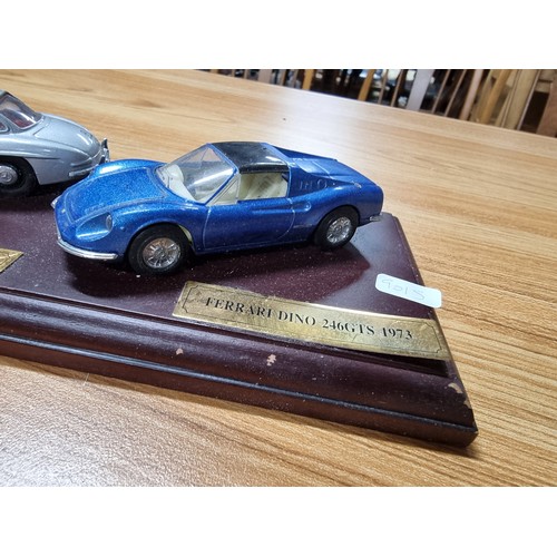 16 - A Dinky 3x model diecast sports car set all attached to a presentation plinth to include a Ferrari D... 