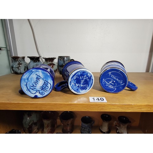 140 - 13x Ewenny Ware studio pottery pieces inc tankards and vases all of different colours inc a royal co... 