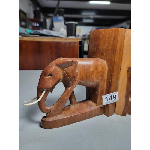 149 - Pair of hand carved elephant formed book ends in good order with metal and plastic tusks, each book ... 