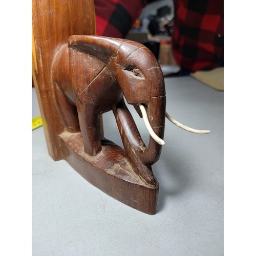 149 - Pair of hand carved elephant formed book ends in good order with metal and plastic tusks, each book ... 