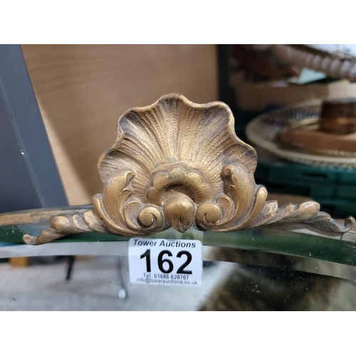 162 - Good quality bevel edged mirror with ornate shell crest to the top in good order height 45cm length ... 