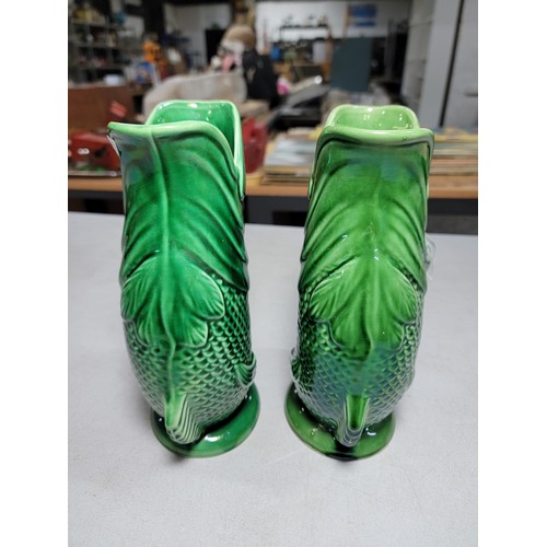 306 - 2x large green fish formed Darmouth Devon glug jugs, one has damage to the base height 24cm