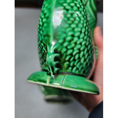 306 - 2x large green fish formed Darmouth Devon glug jugs, one has damage to the base height 24cm