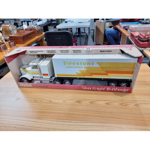 34 - A boxed unused Nylint Silver Knight NO.345 large scale steel model 18 wheeler truck with firestone a... 