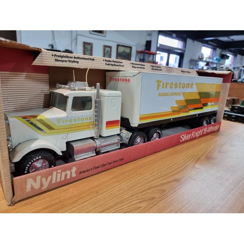 34 - A boxed unused Nylint Silver Knight NO.345 large scale steel model 18 wheeler truck with firestone a... 