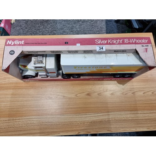 34 - A boxed unused Nylint Silver Knight NO.345 large scale steel model 18 wheeler truck with firestone a... 