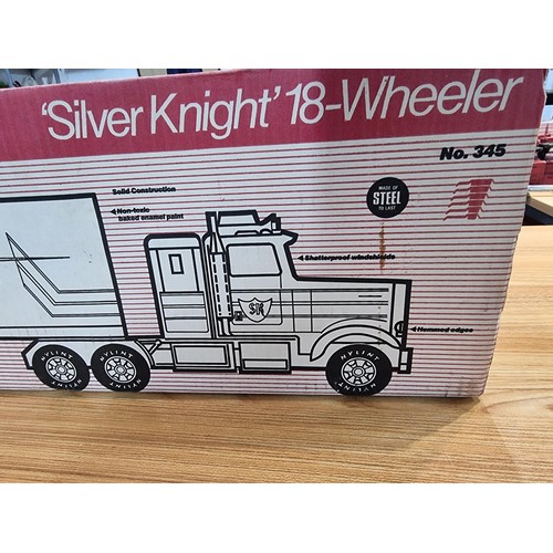 34 - A boxed unused Nylint Silver Knight NO.345 large scale steel model 18 wheeler truck with firestone a... 