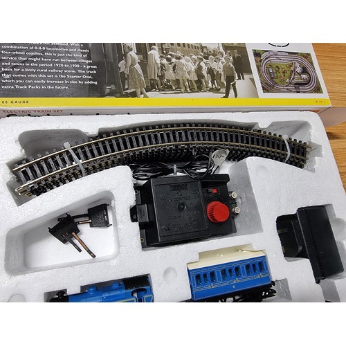 52 - A boxed Hornby R1016 Caledonian local train set, complete. Includes locomotive, 3 matching coaches a... 