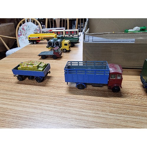 58 - A box full of various diecast and plastic model vehicles many relating to model railway trackside to... 