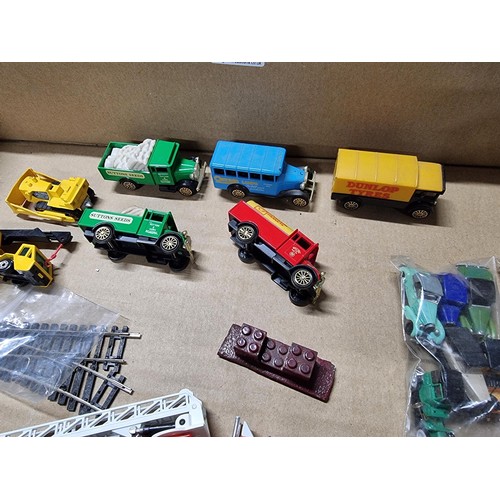 58 - A box full of various diecast and plastic model vehicles many relating to model railway trackside to... 