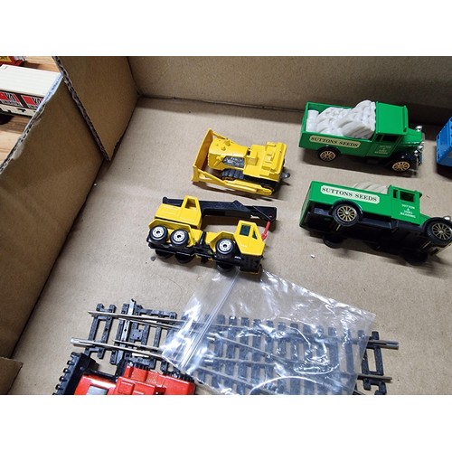 58 - A box full of various diecast and plastic model vehicles many relating to model railway trackside to... 