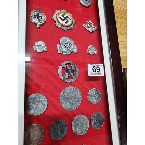 69 - 2 large framed and display boxes containing a large quantity of reproduction WWII German regalia pre... 