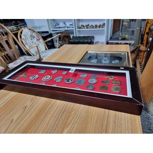 69 - 2 large framed and display boxes containing a large quantity of reproduction WWII German regalia pre... 