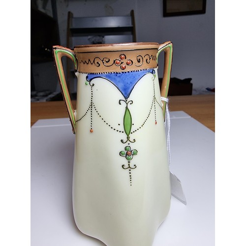 174 - A very pretty quality hand painted twin handled vase by Noritake Japan featuring a hand painted flor... 