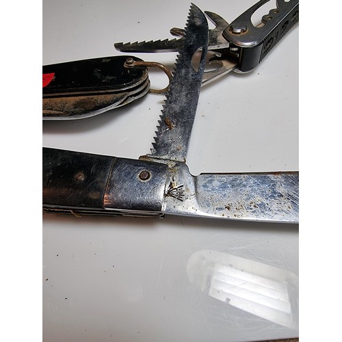 178 - 2 large folding knives along with a multi tool knife featuring pliers, saws, screwdrivers, etc. The ... 