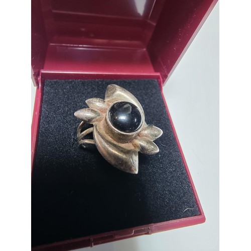 184 - A 925 silver ring inset with a lack onyx stone, in clean condition and boxed, size O.