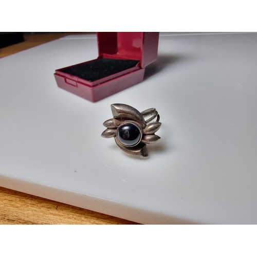 184 - A 925 silver ring inset with a lack onyx stone, in clean condition and boxed, size O.