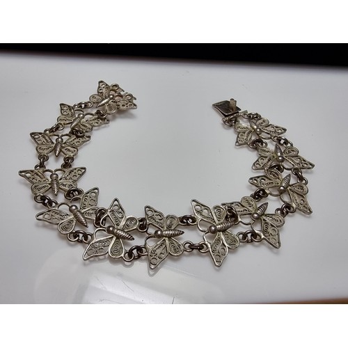 188 - An 800 solid silver pretty filigree butterfly panel bracelet in excellent clean condition, presentin... 