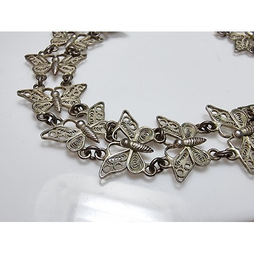 188 - An 800 solid silver pretty filigree butterfly panel bracelet in excellent clean condition, presentin... 