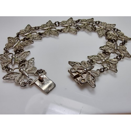 188 - An 800 solid silver pretty filigree butterfly panel bracelet in excellent clean condition, presentin... 