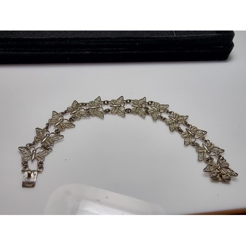 188 - An 800 solid silver pretty filigree butterfly panel bracelet in excellent clean condition, presentin... 