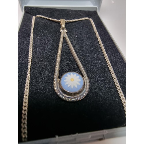 230 - A 925 hallmarked silver pendant with a blue bisque flower insert set on a good 18